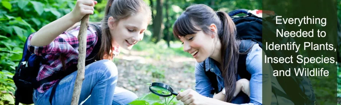 A female teacher and student looking through a magnifying glass while out in the field.