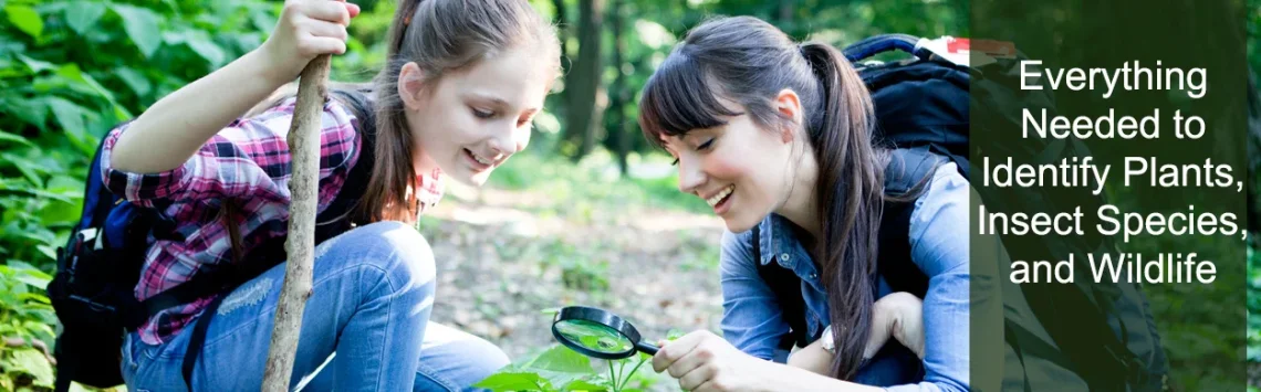 A female teacher and student looking through a magnifying glass while out in the field.