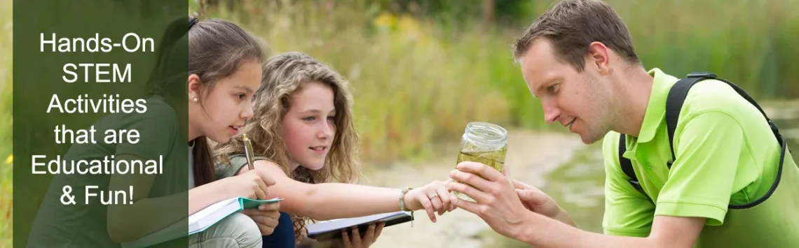 Male teacher showing 2 girls the contents of a water sample while out in the field.